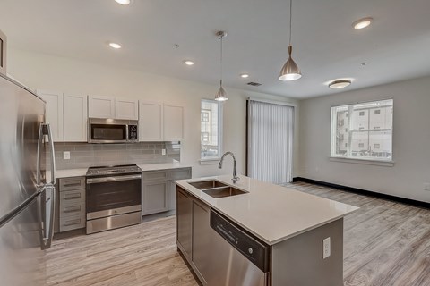 a kitchen with an island and stainless steel appliances